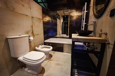 a bathroom with a toilet and a sink and a tub at Terra Firma Hotel Boutique in Villa Carlos Paz