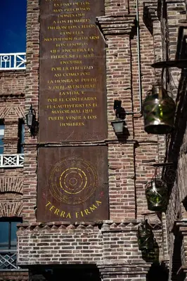 a sign on the side of a brick building at Terra Firma Hotel Boutique in Villa Carlos Paz