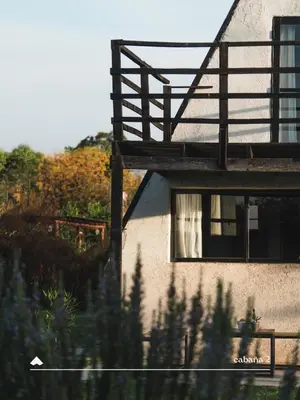 a building with a window with a curtain in it at COMPLEJO ISABELLA in Villa Amancay