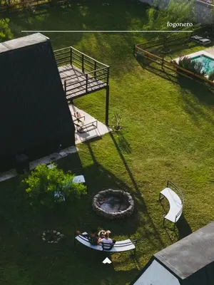 two people are laying on a raft in the grass at COMPLEJO ISABELLA in Villa Amancay
