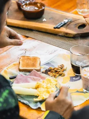 a person sitting at a table with a plate of food at COMPLEJO ISABELLA in Villa Amancay
