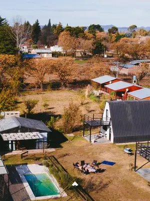 an aerial view of a farm with a pool and buildings at COMPLEJO ISABELLA in Villa Amancay