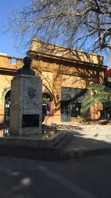 a monument in front of a building with a statue at Plazoleta Apartamento in Cordoba