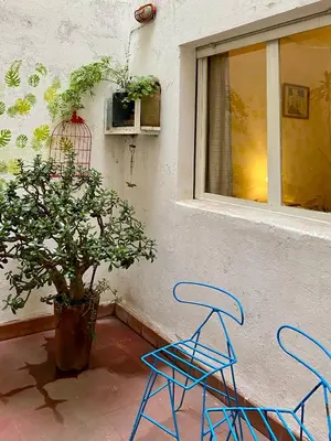 two blue chairs sitting next to a window at Plazoleta Apartamento in Cordoba
