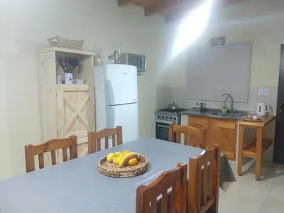 a kitchen with a table with a bowl of fruit on it at ALA DE LIBERTAD in Villa Yacanto