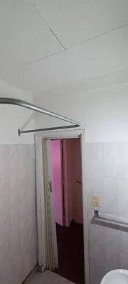 a bathroom with a pink door and a hallway at Salguero Centric Apartaments D2 in Cordoba