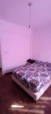 a bedroom with a bed with a floral comforter at Salguero Centric Apartaments D2 in Cordoba