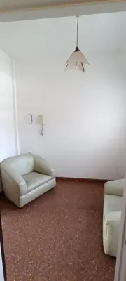 a living room with a white couch and a lamp at Salguero Centric Apartaments D2 in Cordoba