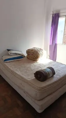 a bed in a room with a purple curtain at Salguero Centric Apartaments D2 in Cordoba