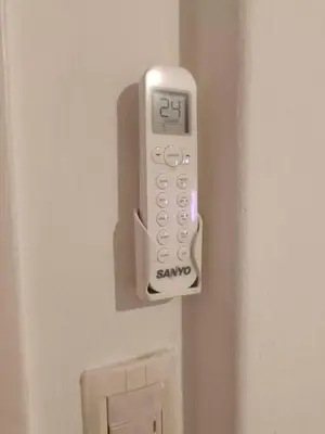 a remote control attached to a door of a bathroom at Salguero Centric Apartaments D2 in Cordoba