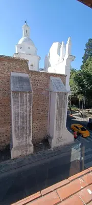 a brick wall with two stone pillars next to a street at Salguero Centric Apartaments D2 in Cordoba