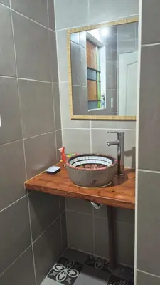 a bathroom with a sink and a mirror at Casa Del Valle Traslasierra in Las Chacras (La Paz)