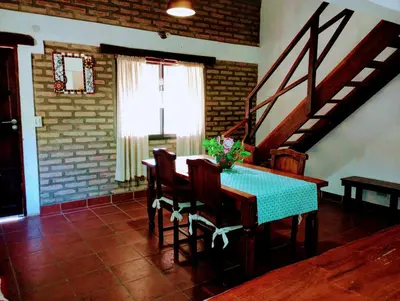 a dining room with a blue table and chairs at Casa Del Valle Traslasierra in Las Chacras (La Paz)