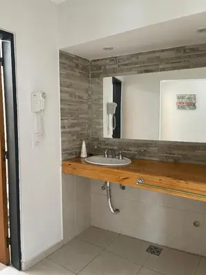 a bathroom with a sink and a mirror at Brisas del Sur in Villa Carlos Paz