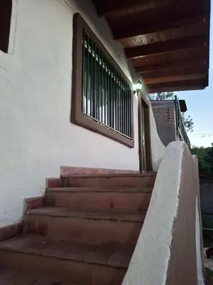 a set of stairs leading up to a building with a window at Casa Calo Bialet Massé in Bialet Massé