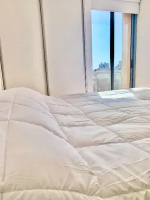 a white bed in a room with a window at Ayres de Córdoba 2, Asador, Terraza, Balcón, Excelente Ubicación in Cordoba