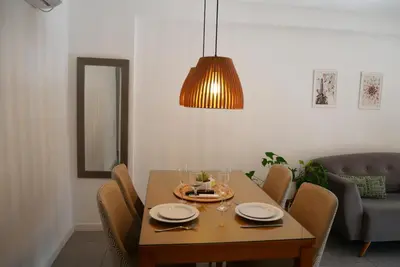 a dining room table with chairs and a light fixture at A estrenar!Moderno, Nordic Nest in Cordoba