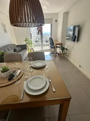 a dining room table with plates and wine glasses on it at A estrenar!Moderno, Nordic Nest in Cordoba