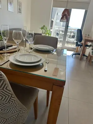 a dining table with plates and wine glasses on it at A estrenar!Moderno, Nordic Nest in Cordoba
