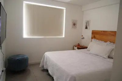 a bedroom with a white bed and a window at A estrenar!Moderno, Nordic Nest in Cordoba