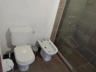 a bathroom with a toilet and a shower and a sink at Cabañas del Cerro Mirador in Villa Rumipal