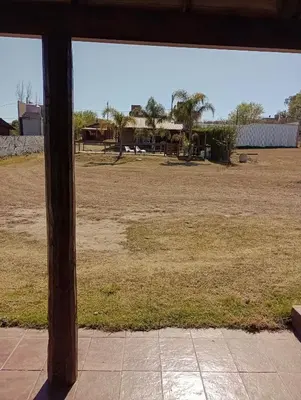 a view of a field from an open window at Cabañas del Cerro Mirador in Villa Rumipal