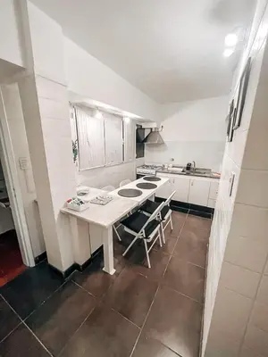 a kitchen with a table and chairs in it at Departamento zona CENTRO BOLIVAR y LA CAÑADA con BALCÓN in Cordoba