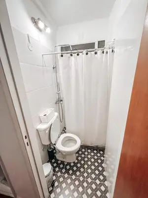 a bathroom with a toilet and a shower curtain at Departamento zona CENTRO BOLIVAR y LA CAÑADA con BALCÓN in Cordoba