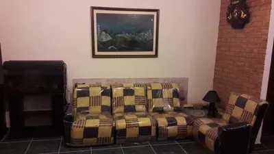 a couch and a chair in a living room at un lindo departamento in Cordoba