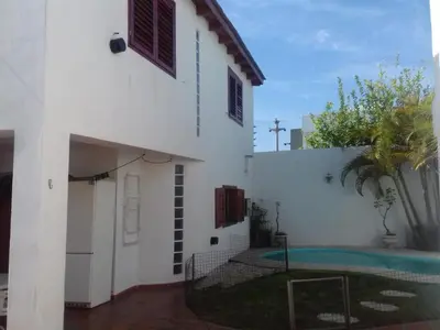 a white house with a pool in front of it at un lindo departamento in Cordoba