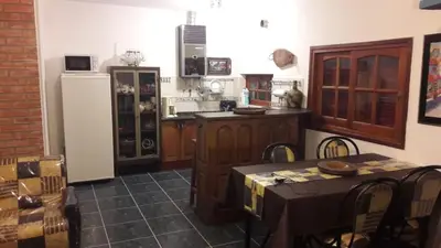 a kitchen with a table and a refrigerator at un lindo departamento in Cordoba