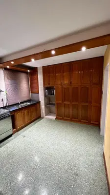 a large kitchen with wooden cabinets and a stove at Verona in Cordoba