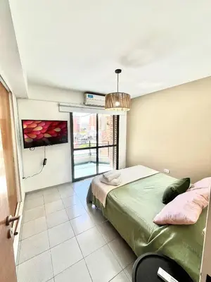 a bedroom with a bed and a large window at NUEVA CÓRDOBA - Vélez Sarsfield cerca del Allende y Oulton in Cordoba