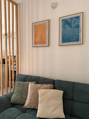 a blue couch in a living room with two pictures on the wall at NUEVA CÓRDOBA - Vélez Sarsfield cerca del Allende y Oulton in Cordoba