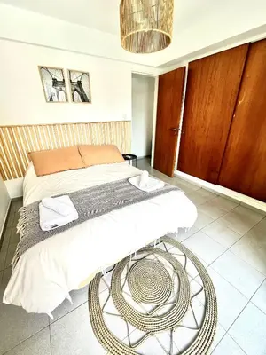 a bedroom with a large bed with a table at NUEVA CÓRDOBA - Vélez Sarsfield cerca del Allende y Oulton in Cordoba