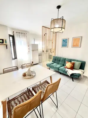 a living room with a table and a green couch at NUEVA CÓRDOBA - Vélez Sarsfield cerca del Allende y Oulton in Cordoba