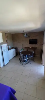 a kitchen with a table and chairs in a room at Gemas Apart in Villa Yacanto