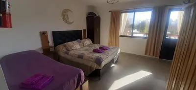 a bedroom with a bed and a window and a bed sidx sidx sidx at Gemas Apart in Villa Yacanto