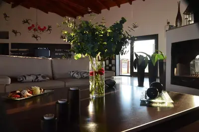 a living room with a vase of flowers on a table at Posada Loma del Tigre in Los Reartes