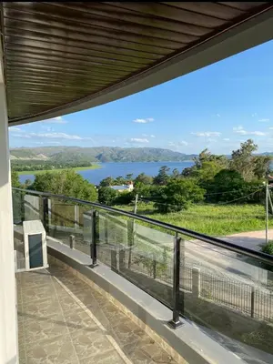 a balcony with a view of a lake at Departamento con vistas al lago en Veneto Village in Villa Parque Siquiman