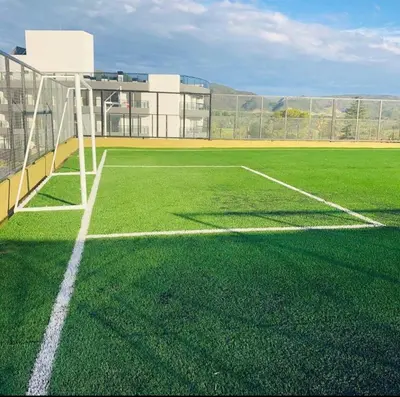 an empty soccer field with a soccer goal at Departamento con vistas al lago en Veneto Village in Villa Parque Siquiman