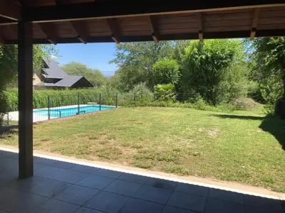 a view of a yard with a swimming pool at LA CASONA in Villa General Belgrano