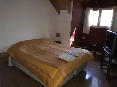 a bedroom with a bed with two towels on it at LA CASONA in Villa General Belgrano