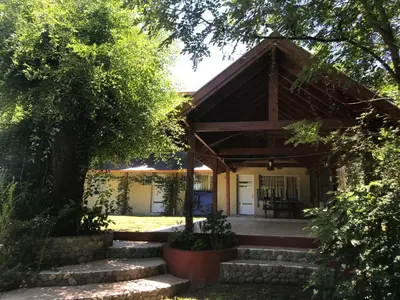 a house with stairs leading to the front entrance at LA CASONA in Villa General Belgrano