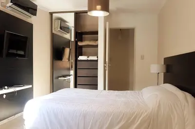 a bedroom with a white bed and a closet at LOAN Nueva Cordoba 4E in Cordoba