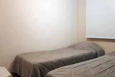 a bedroom with two beds and a window at LOAN Nueva Cordoba 4E in Cordoba
