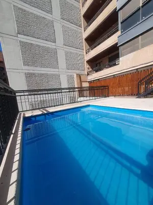 a large swimming pool in front of a building at LOAN Nueva Cordoba 4E in Cordoba