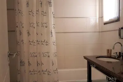 a bathroom with a shower curtain with writing on it at LOAN Nueva Cordoba 4E in Cordoba