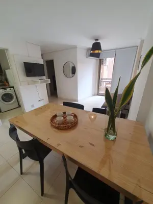 a wooden table with a vase on it in a kitchen at LOAN Nueva Cordoba 4E in Cordoba