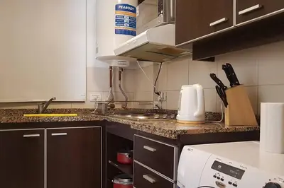 a kitchen with a counter with a stove top oven at LOAN Nueva Cordoba 4E in Cordoba